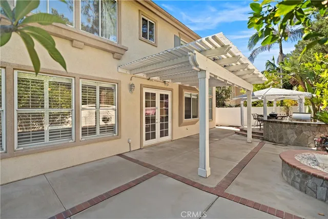 a view of a patio with table and chairs and potted plants