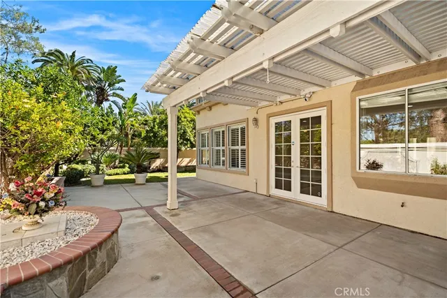 a view of a patio with table and chairs and potted plants