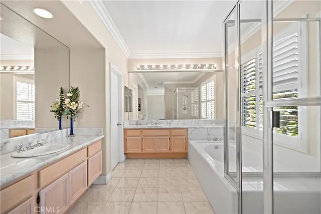 a spacious bathroom with a granite countertop sink a mirror a shower and a bathtub