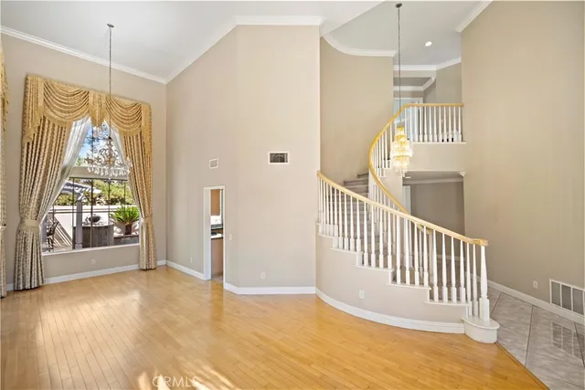 a view of a hallway with wooden floor and windows