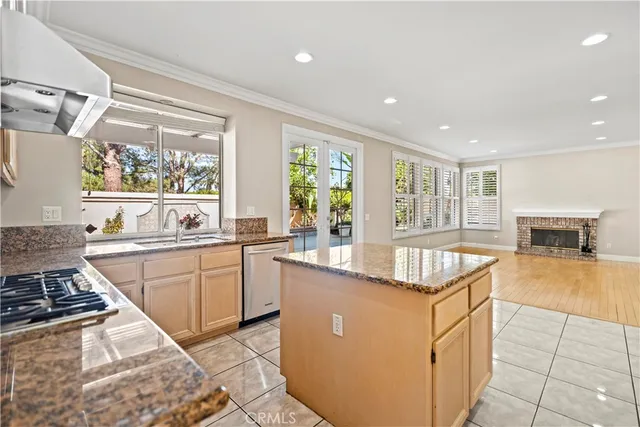 a kitchen with granite countertop a sink stove and cabinets