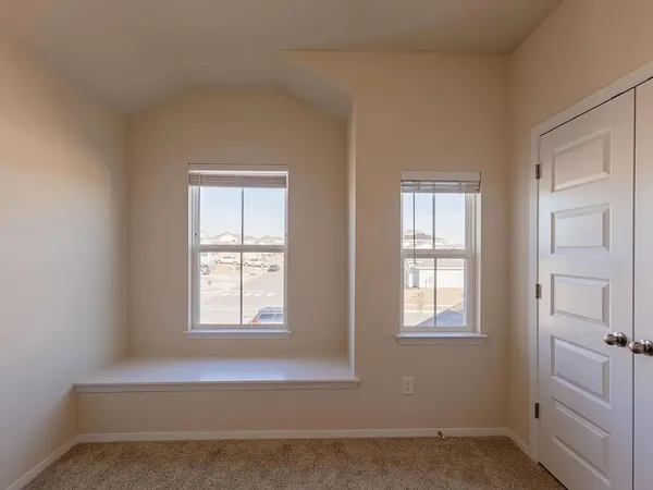 a view of wooden floor and windows in a room