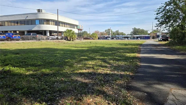 a view of a big yard with large trees and plants
