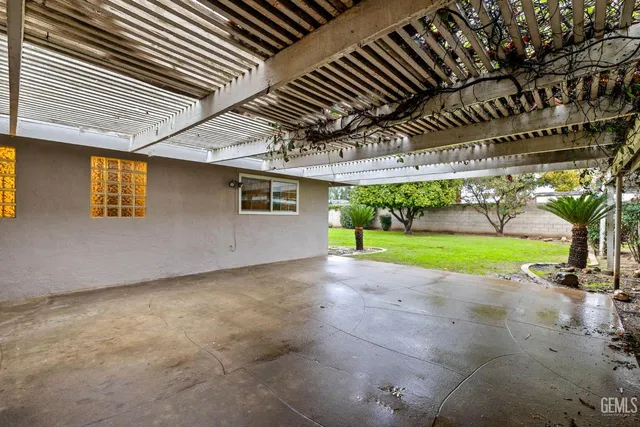 a large white kitchen with a sink and dishwasher a refrigerator with white cabinets
