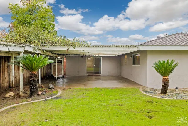 a view of a house with a swimming pool and a yard