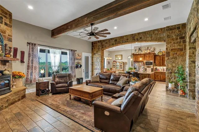 a living room with furniture and a chandelier