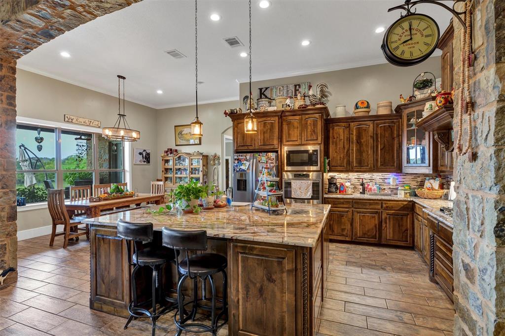 1000 Billings Road Tolar, TX 76476 - Photo 13 of 40 a kitchen with a table and chairs in it