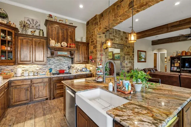 a kitchen with stainless steel appliances granite countertop a sink and cabinets
