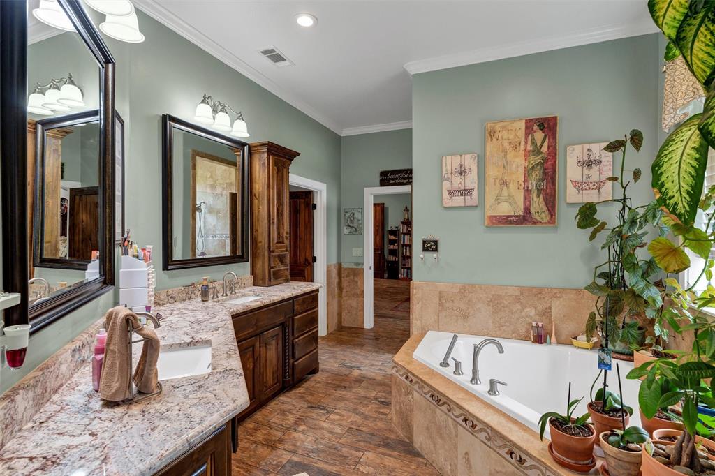 1000 Billings Road Tolar, TX 76476 - Photo 20 of 40 a bathroom with a tub a sink and a large mirror
