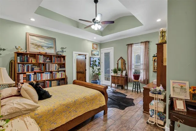 a bedroom with bed and a chandelier