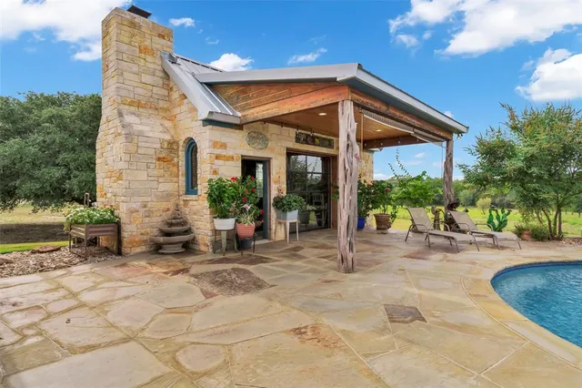 a view of a house with backyard porch and sitting area