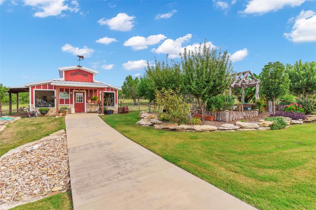 1000 Billings Road Tolar, TX 76476 - Photo 31 of 40 a view of a swimming pool with a garden