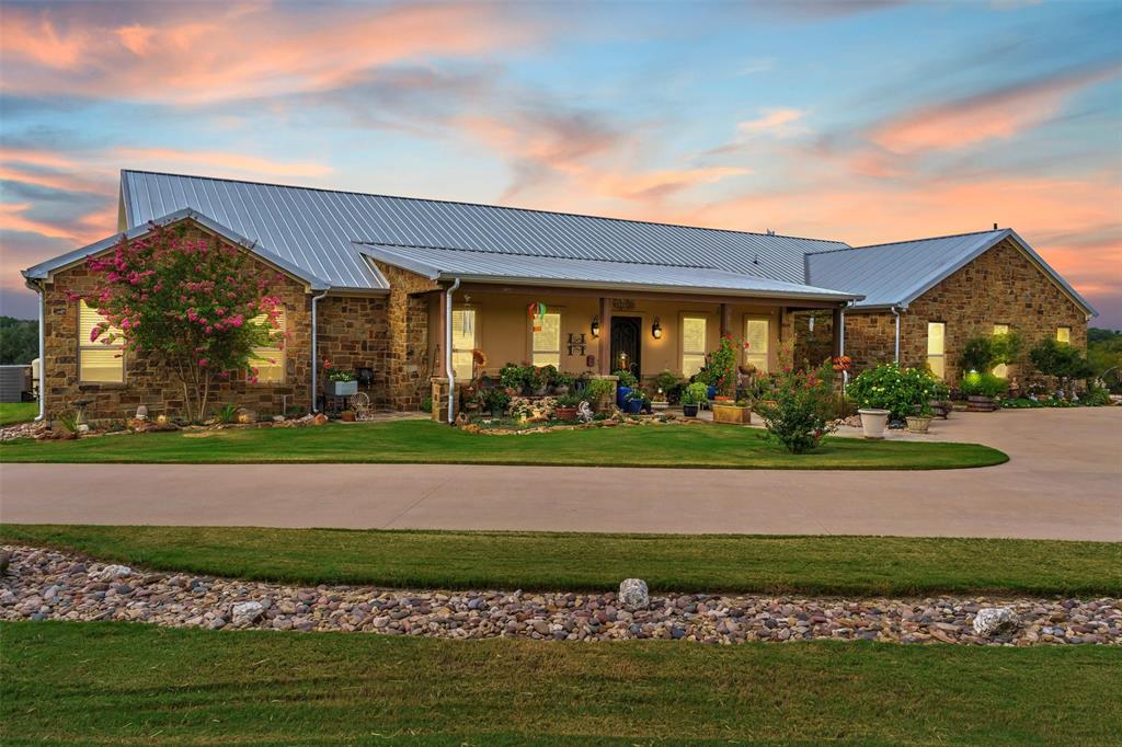 1000 Billings Road Tolar, TX 76476 - Photo 6 of 40 a view of a big house with a big yard and potted plants
