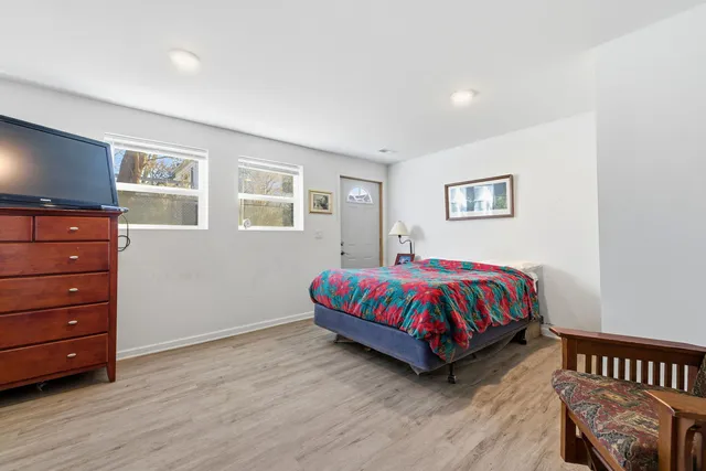 a spacious bedroom with a bed and window