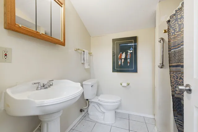a white toilet sitting next to a bathroom sink