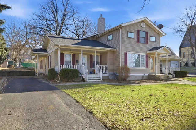 a view of a house with swimming pool and a yard in front of it