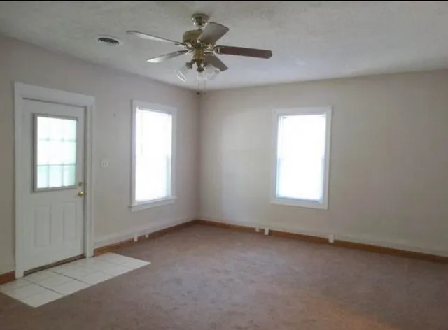 an empty room with a empty space and a window