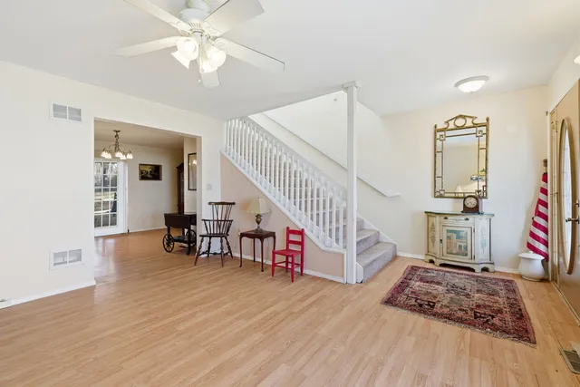 a bedroom with furniture and a wooden floor