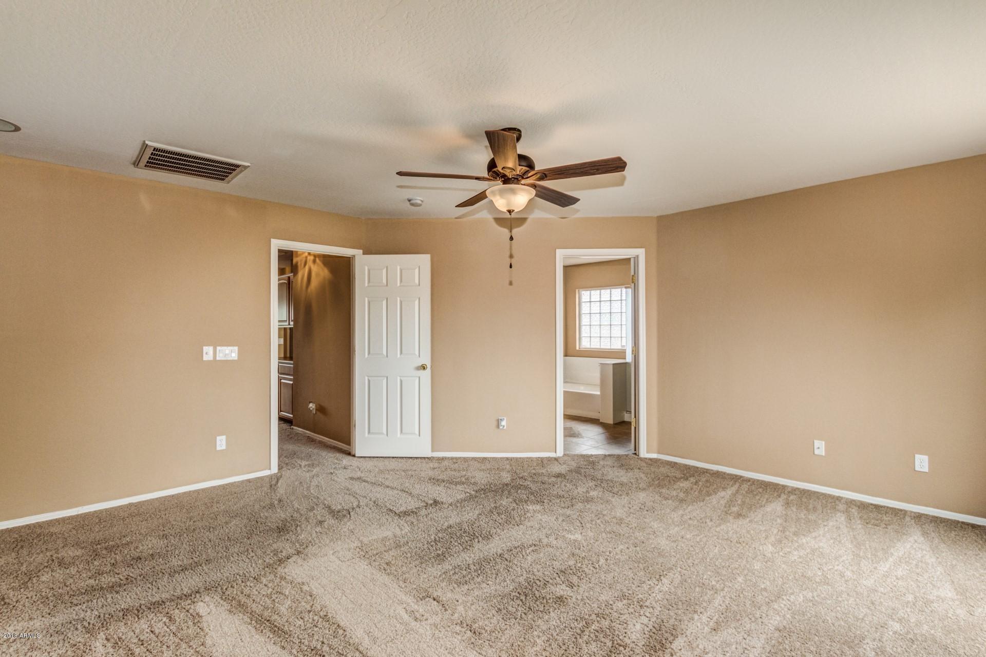 15770 West Calavar Road Surprise, AZ 85379 - Photo 12 of 21 a view of a livingroom with a ceiling fan and window