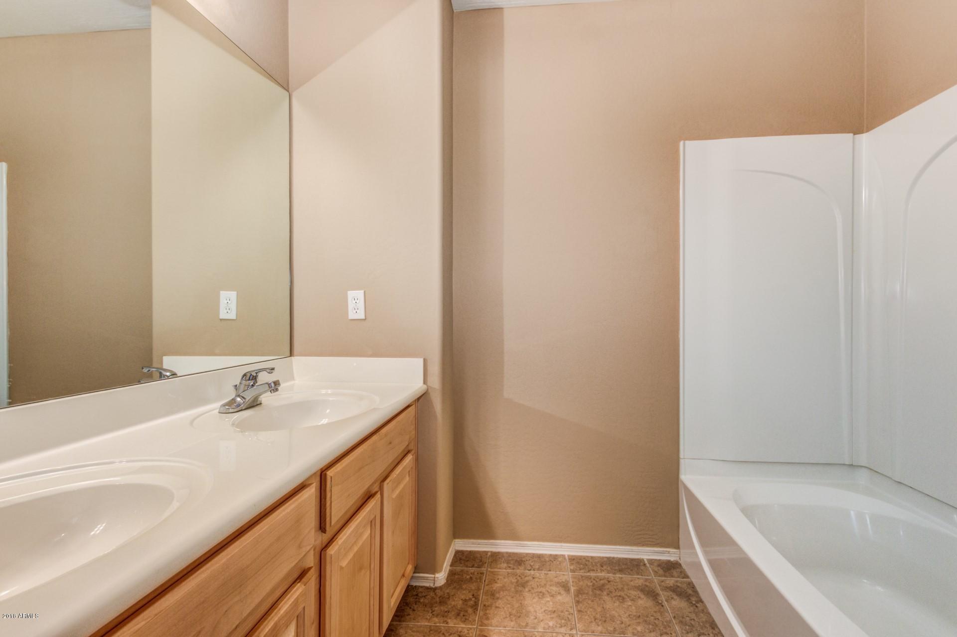 15770 West Calavar Road Surprise, AZ 85379 - Photo 15 of 21 a bathroom with a sink and a bathtub