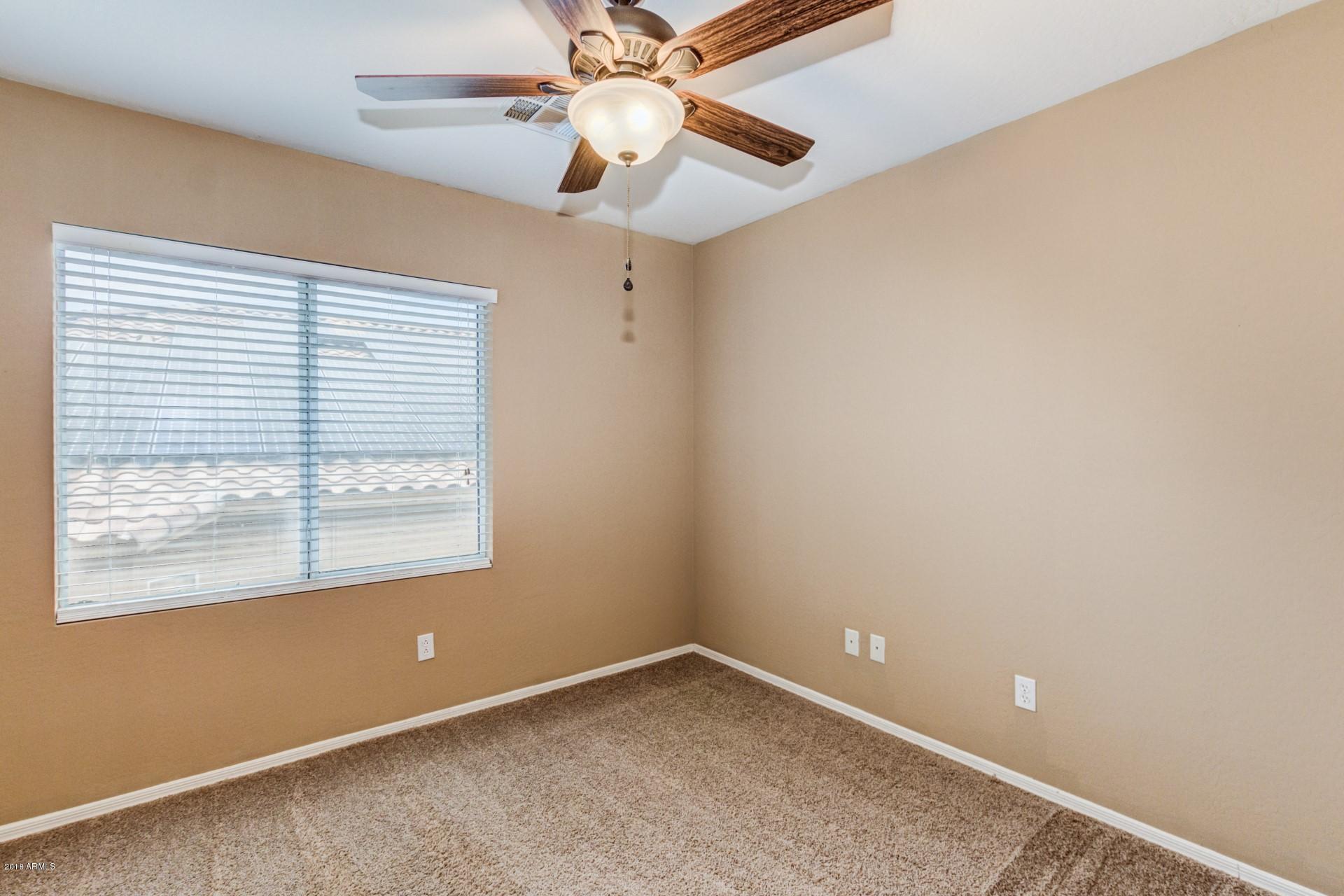 15770 West Calavar Road Surprise, AZ 85379 - Photo 18 of 21 an empty room with a window and a fan