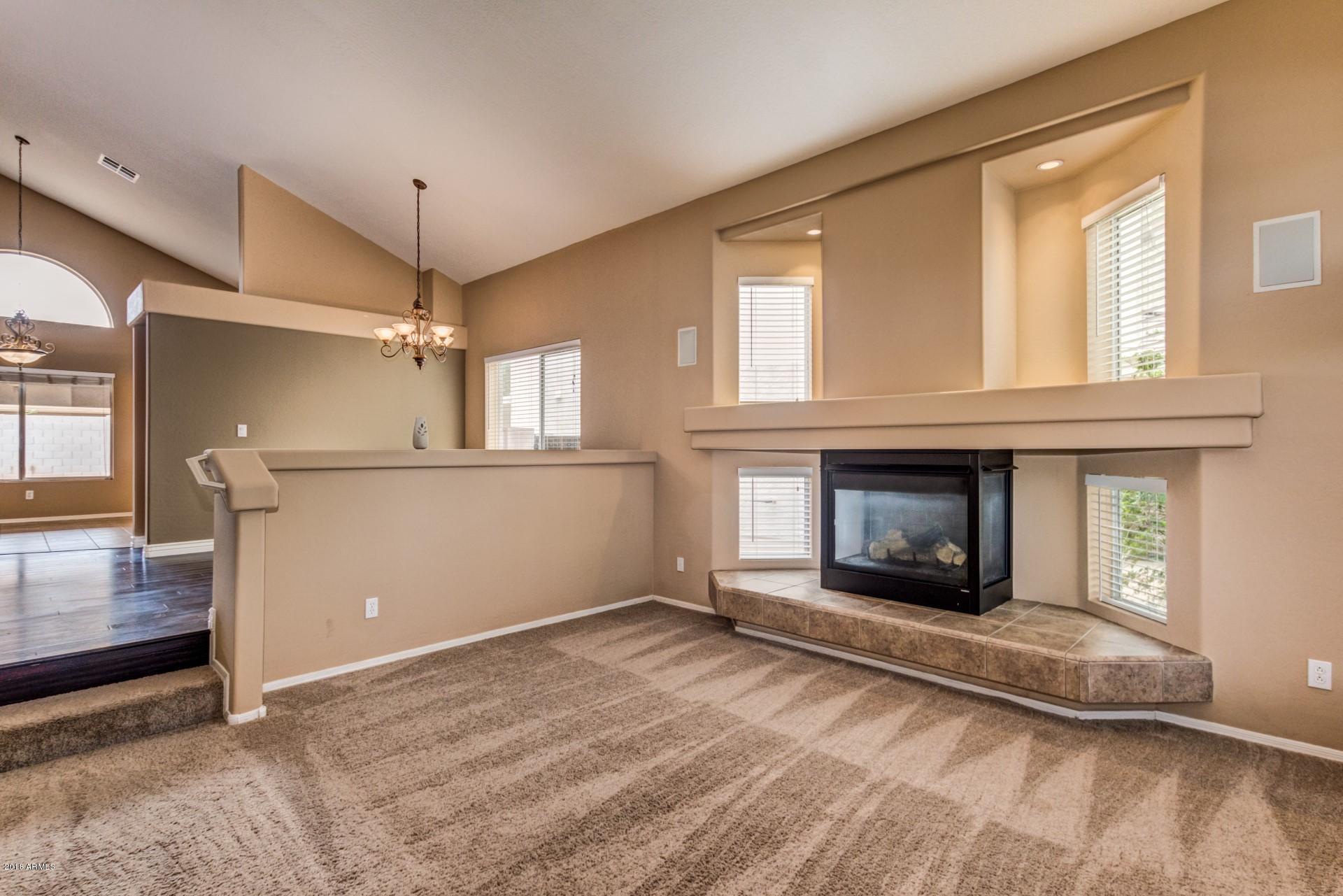 15770 West Calavar Road Surprise, AZ 85379 - Photo 2 of 21 a view of an empty room with window and fire place
