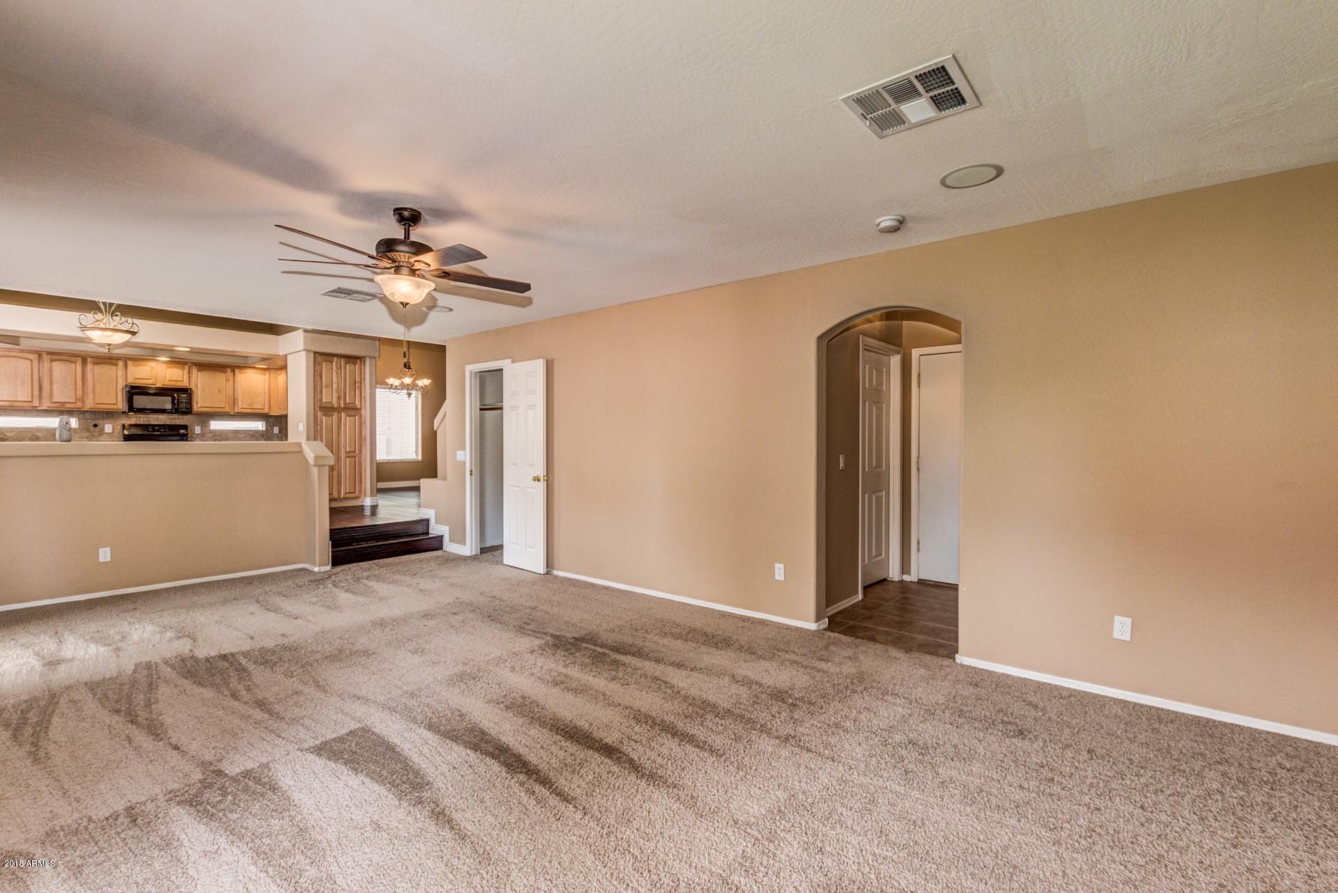 15770 West Calavar Road Surprise, AZ 85379 - Photo 9 of 21 Family room toward laundry and 1/2 bath