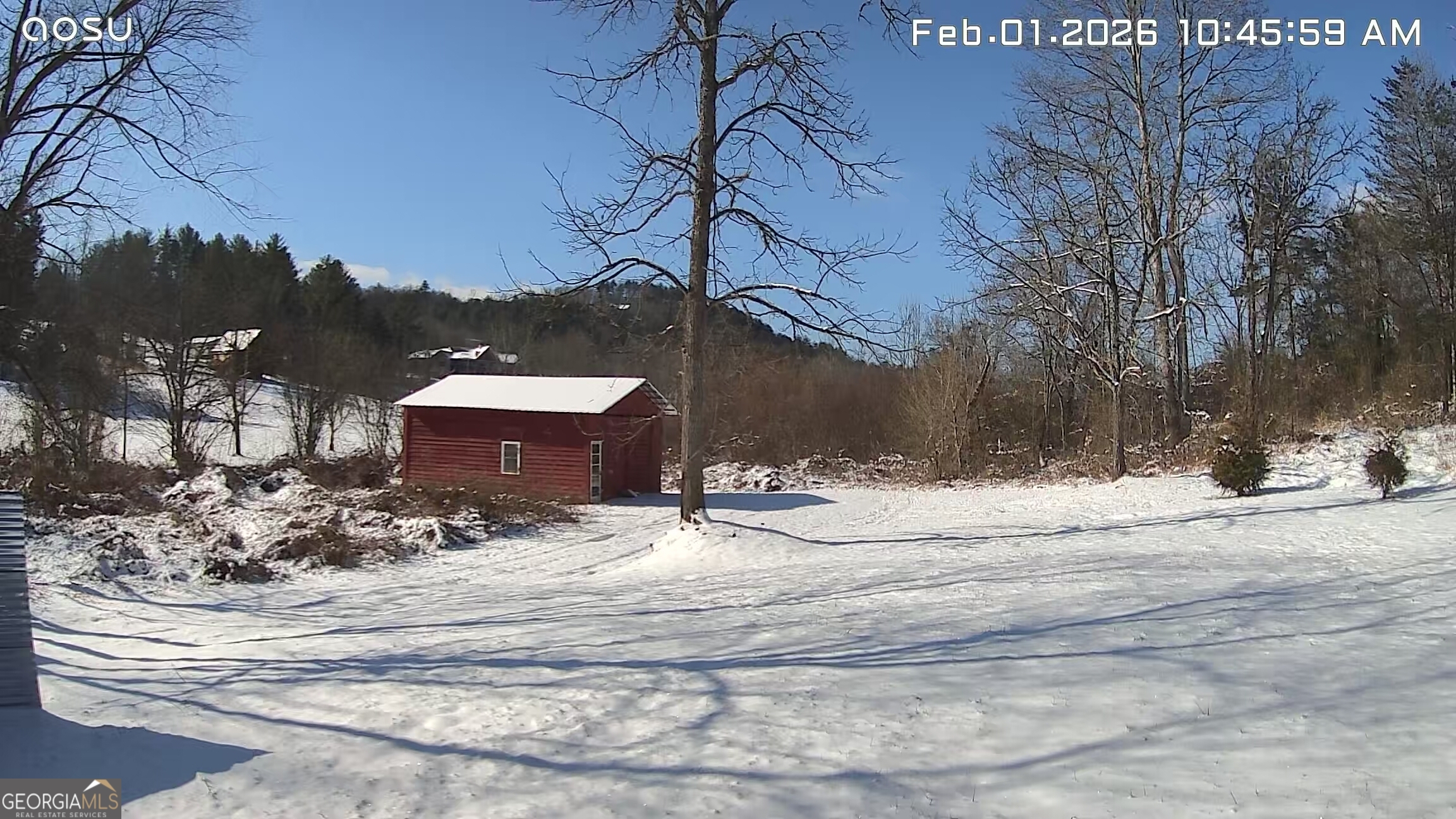 a view of a house with a yard covered in snow
