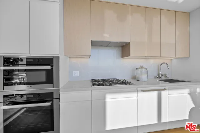 a view of a living room and kitchen with furniture