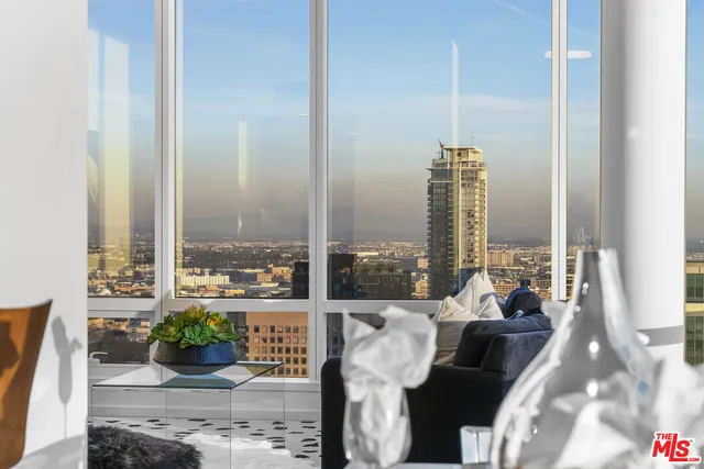 a large bed sitting in a bedroom and a table