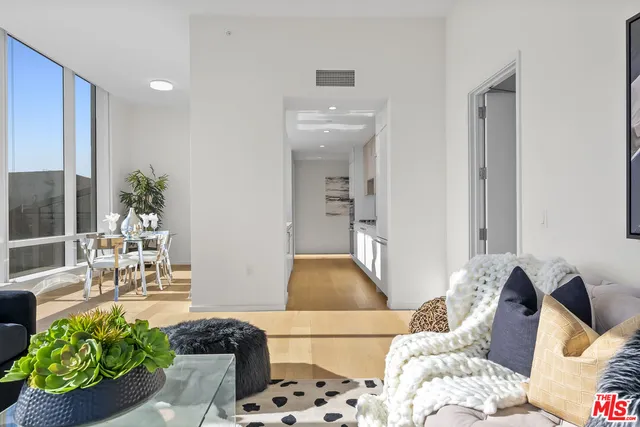 a room with a table chairs and a view of living room