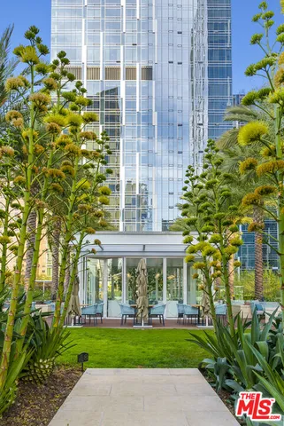 a patio with a table and chairs under an umbrella