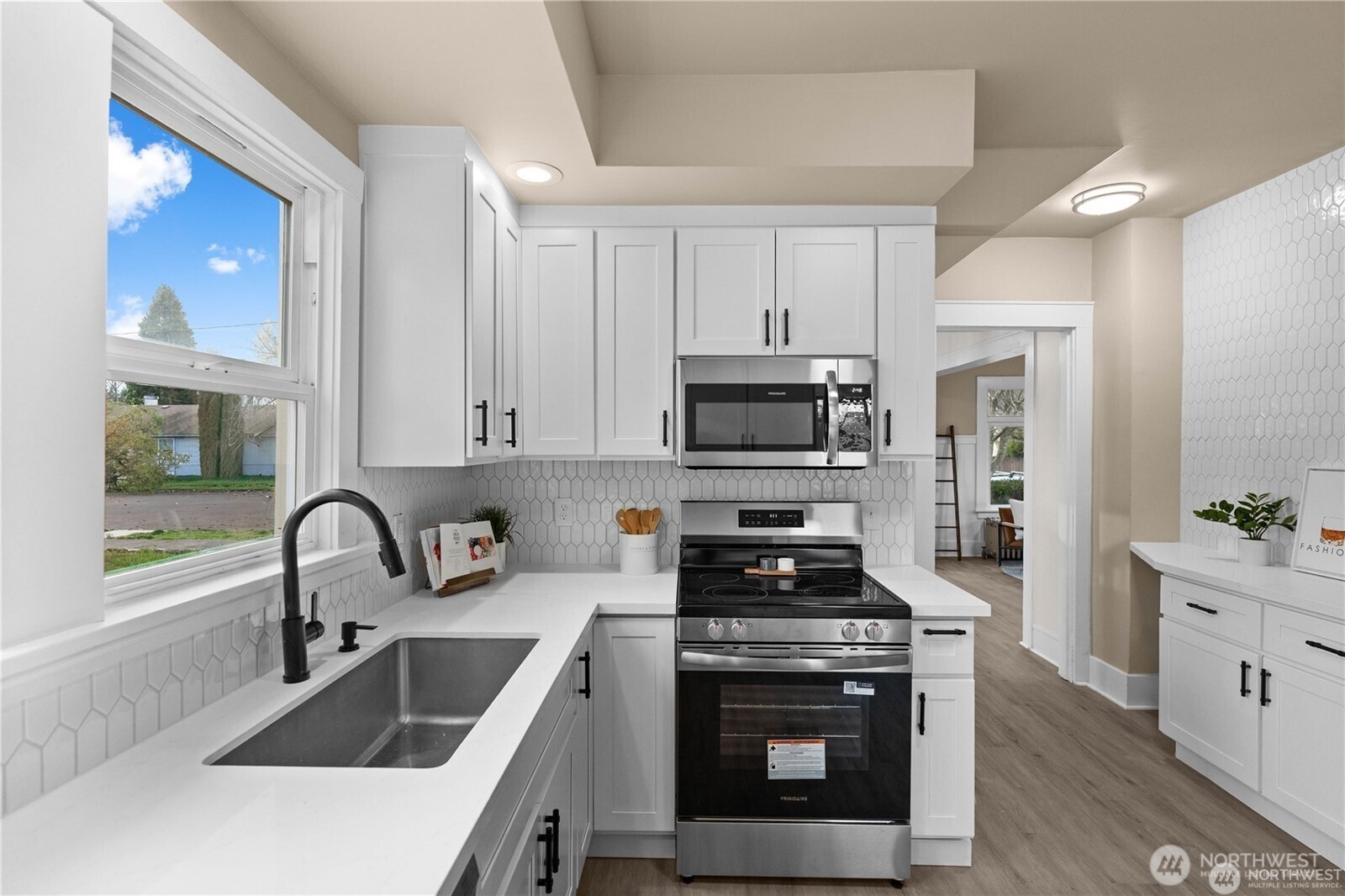 709 South Cedar Street Tacoma, WA 98405 - Photo 13 of 39 a kitchen with sink a stove and microwave