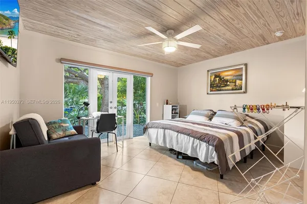 a bedroom with a balcony a bed and a couch