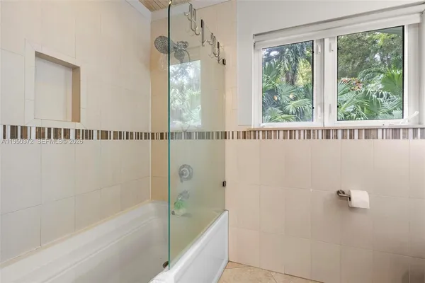 a bathroom with a shower and a bathtub