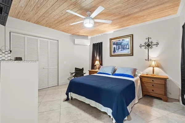 a bed room with a bed and a ceiling fan