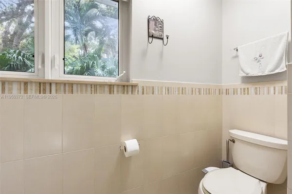 a white toilet sitting next to a window