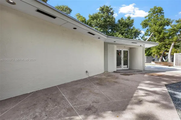 a view of a backyard with a large tree