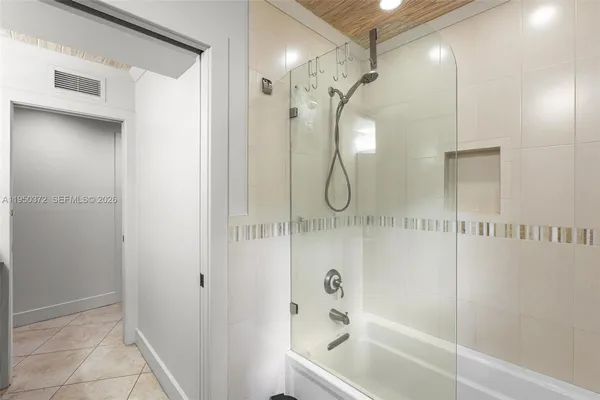 a bathroom with a shower a mirror and a shower