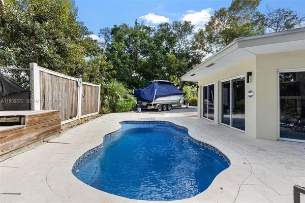a swimming pool with outdoor seating and yard