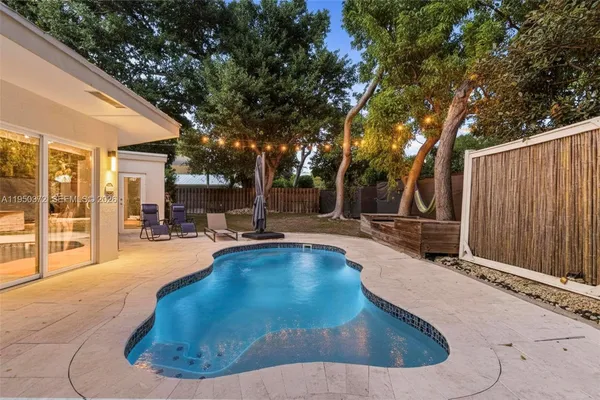 a view of swimming pool with outdoor seating