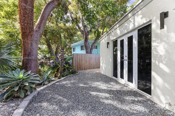 a view of a house with a tree in the background