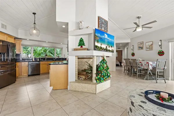a living room with furniture a fireplace and a chandelier