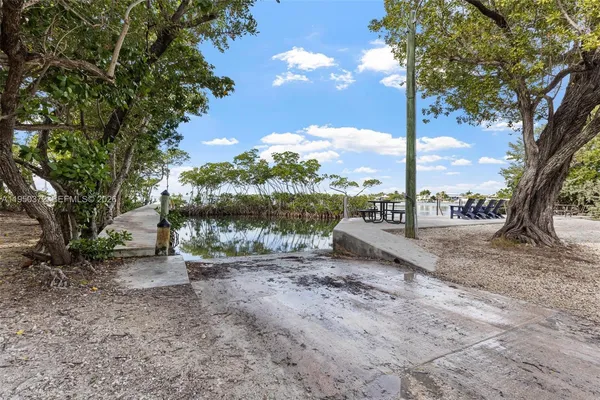 a view of a lake with outside dining space