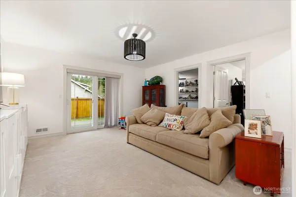 a living room with furniture and a walk in closet