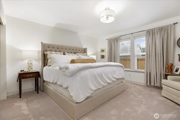 a bedroom with furniture and a flat screen tv