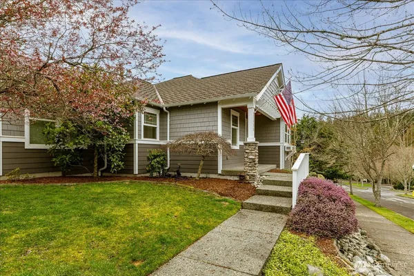 a view of a house with a yard patio and fire pit