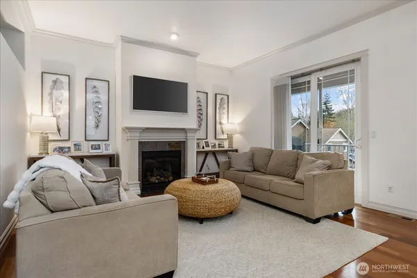 a living room with furniture a flat screen tv and a fireplace