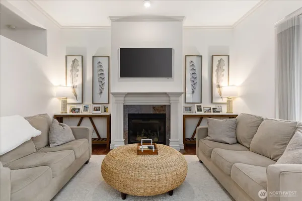 a living room with furniture a flat screen tv and a fireplace
