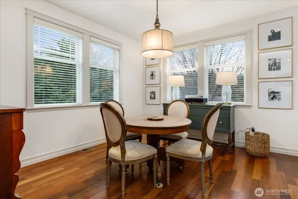 a view of a dining room with furniture window and wooden floor